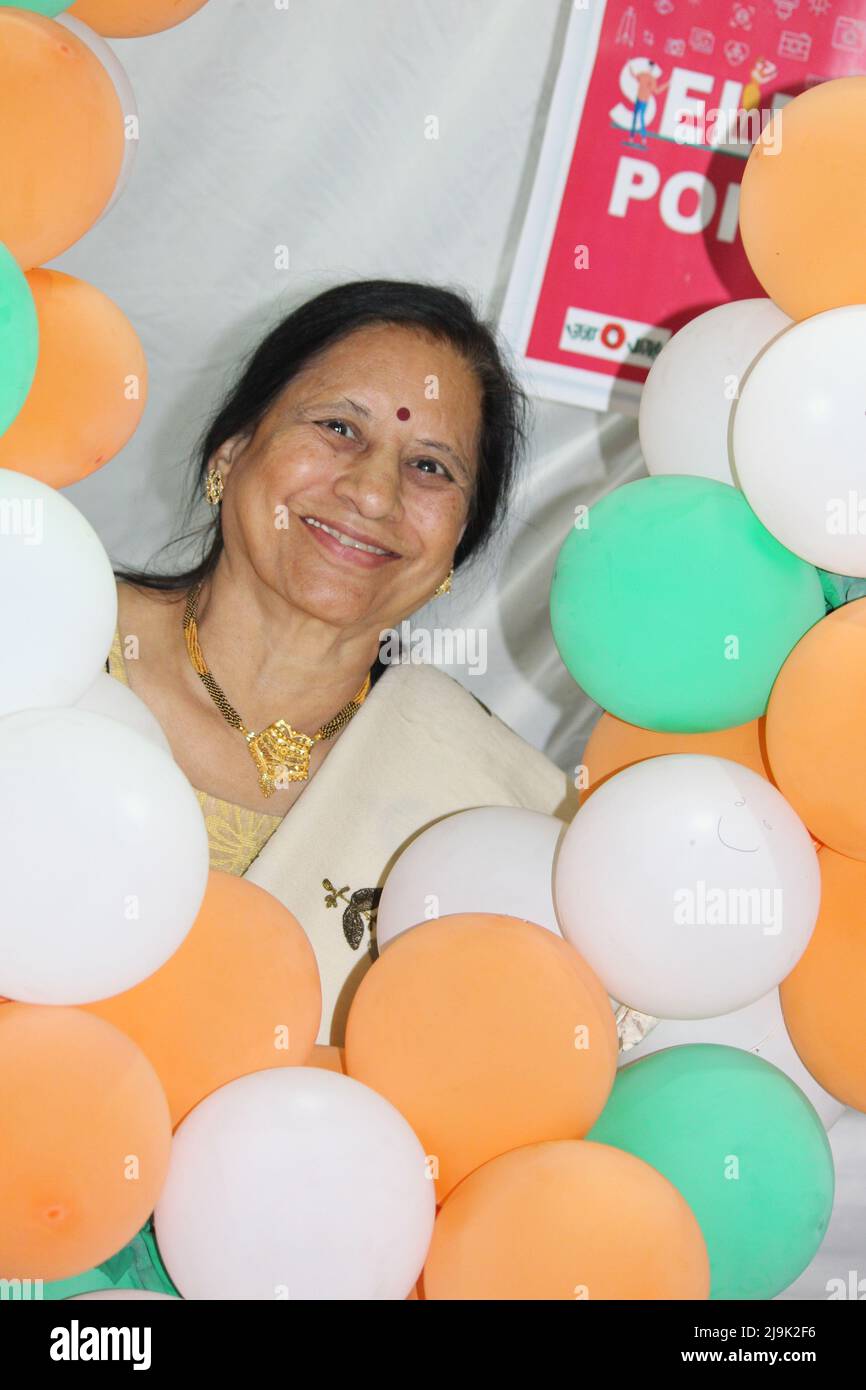 Indian Portrait with tri colour balloons - Saluting national Flag and celebrating Independence or Republic day of India Stock Photo