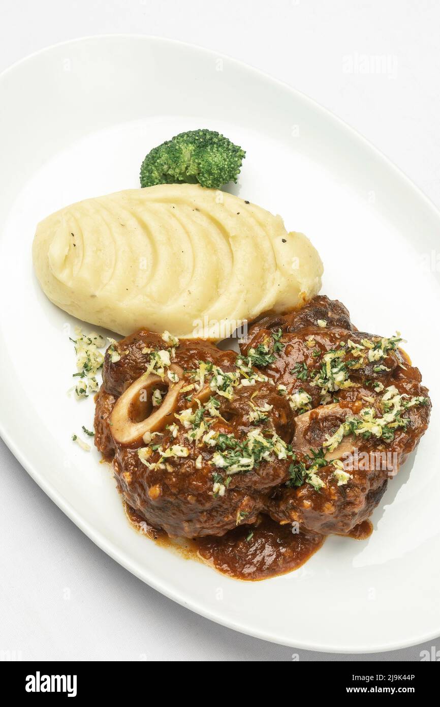 Ossobuco veal shanks with red wine gravy sauce and mashed potato Stock Photo