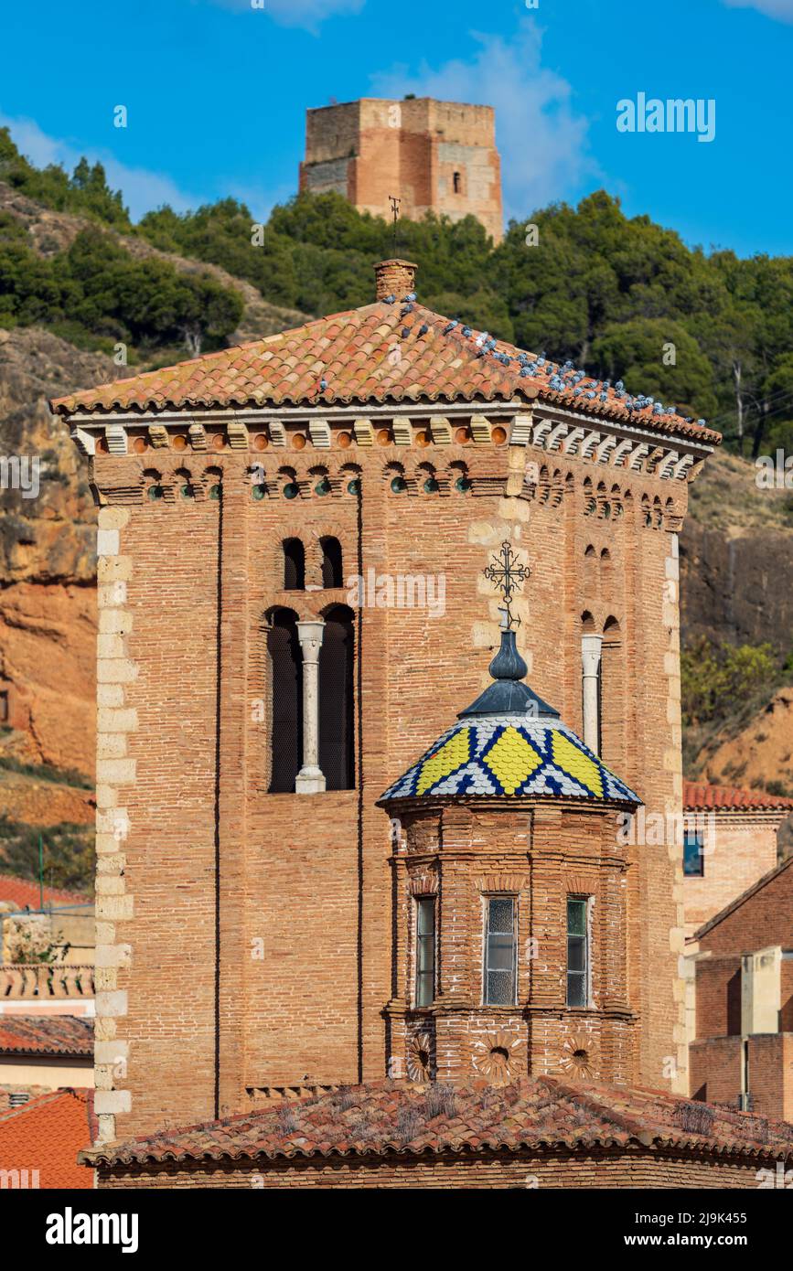 Ancient towers with colorful tile roof and castle in the background ...