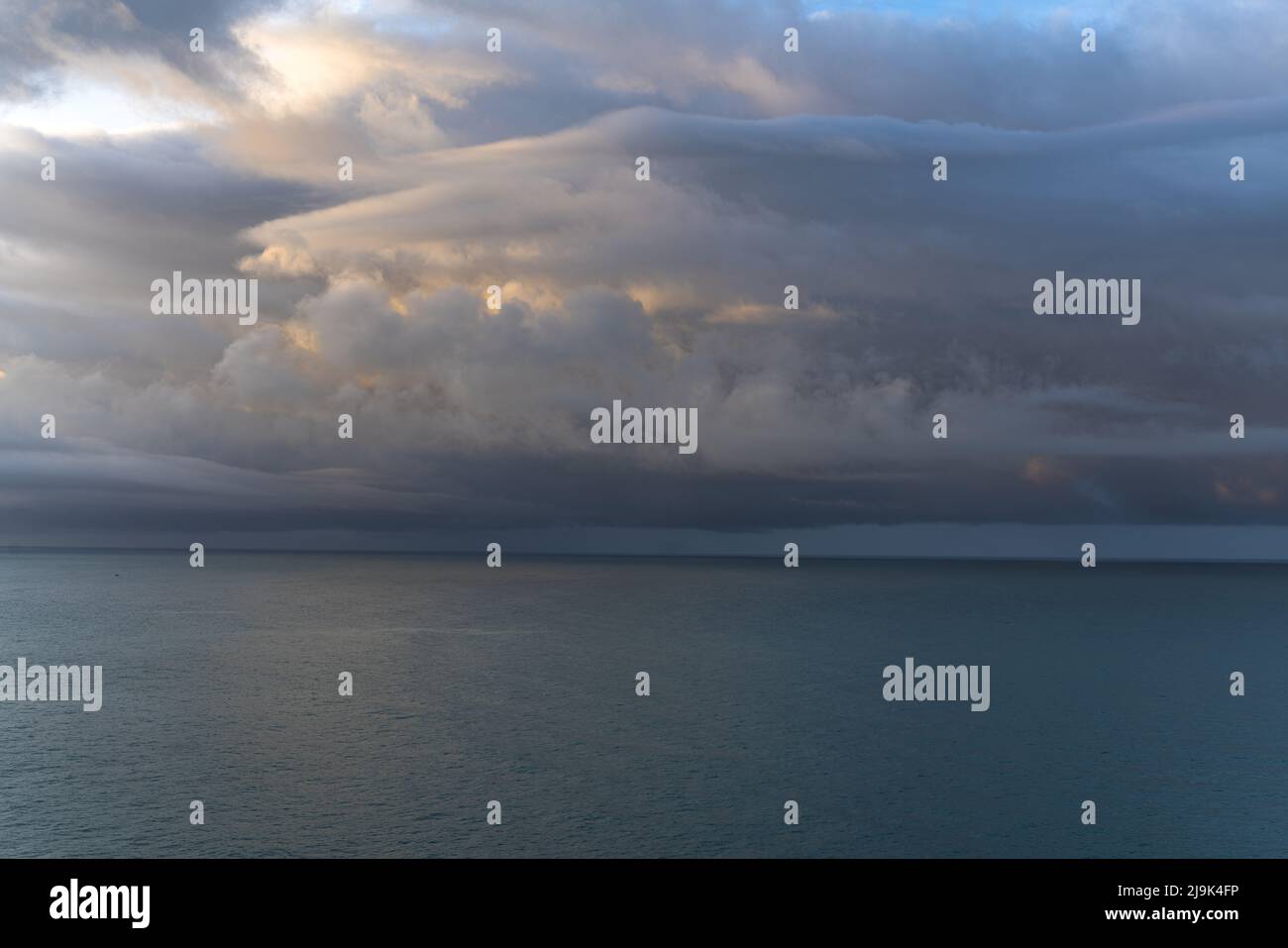 Dramatic sky over the sea at sunrise Stock Photo