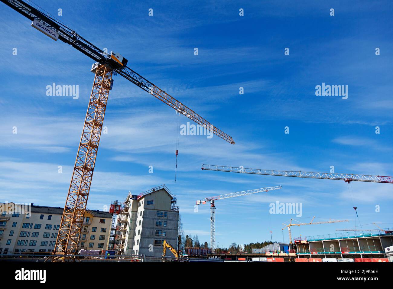 Umea, Norrland Sweden - May 13, 2022: four cranes during housing construction on Teg Stock Photo