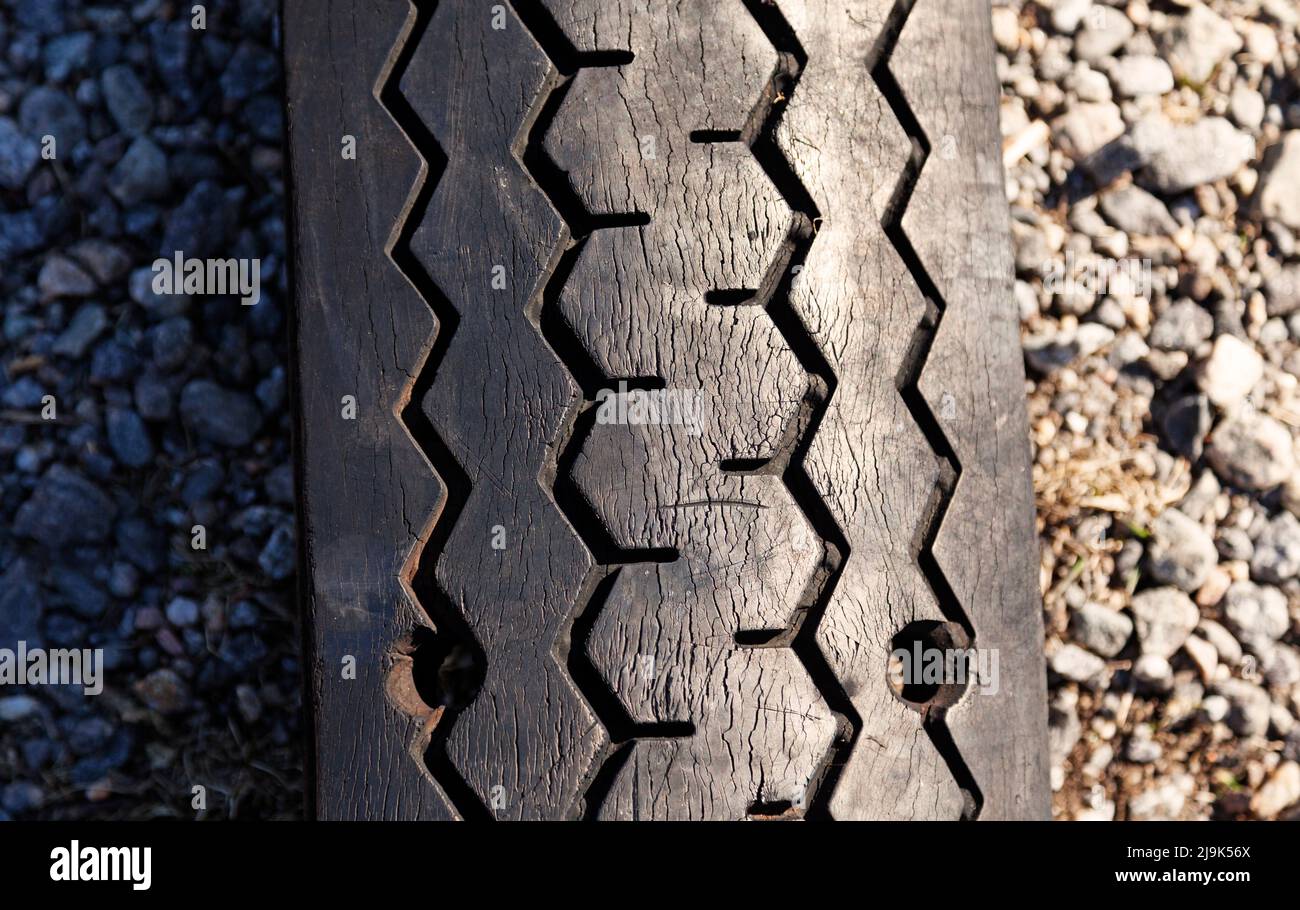 a patterned tire that has been flattened to the ground Stock Photo