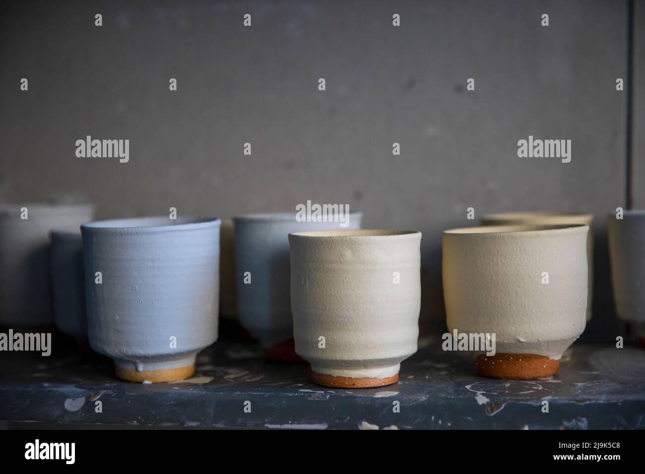 Clay pottery cups drying on shelf Stock Photo Alamy