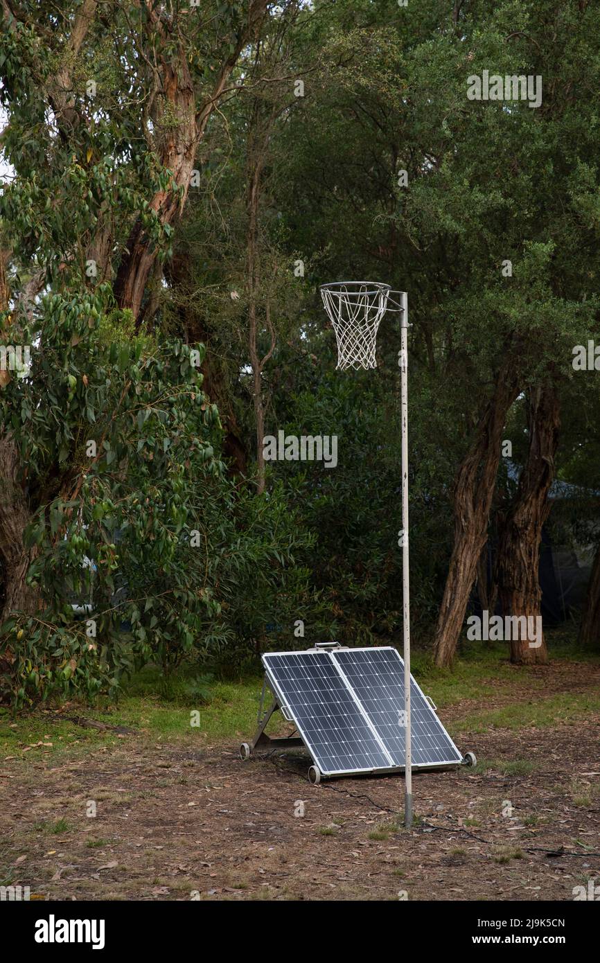 Solar panels below basketball hoop among trees Stock Photo