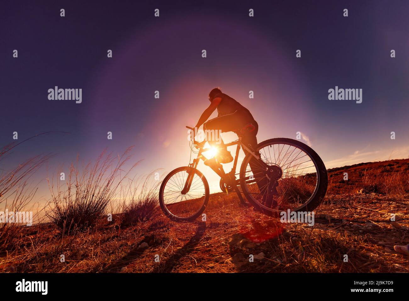 Biker and sunset landscape.leisure in outdoor with mountain bike Stock Photo