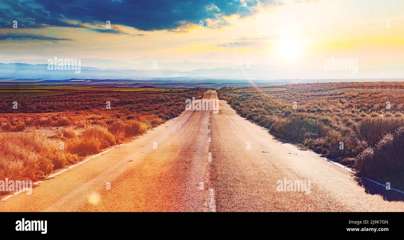 Road and car travel scenic and sunset landscape.Road travel trip concept.Road through landscape. Stock Photo