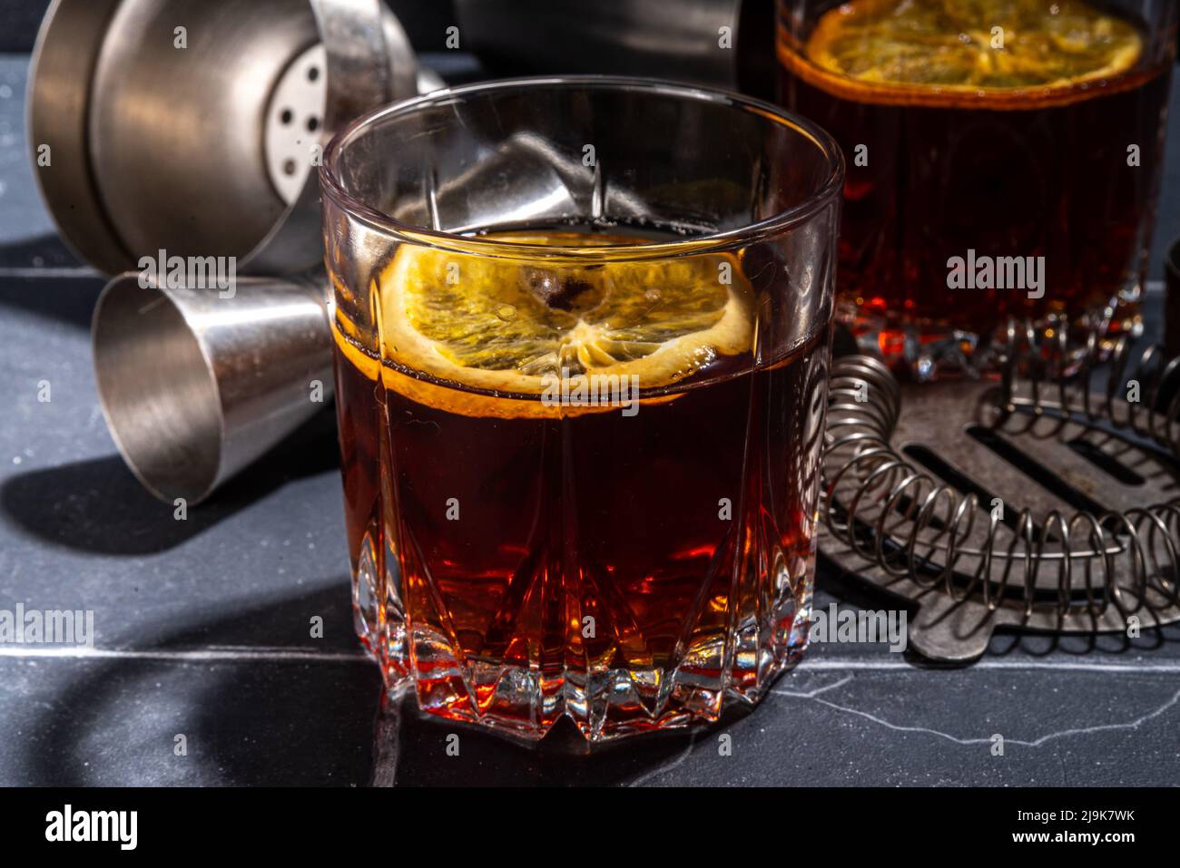 Hard alcohol drink with orange slice garnish. Negroni cocktail with ...