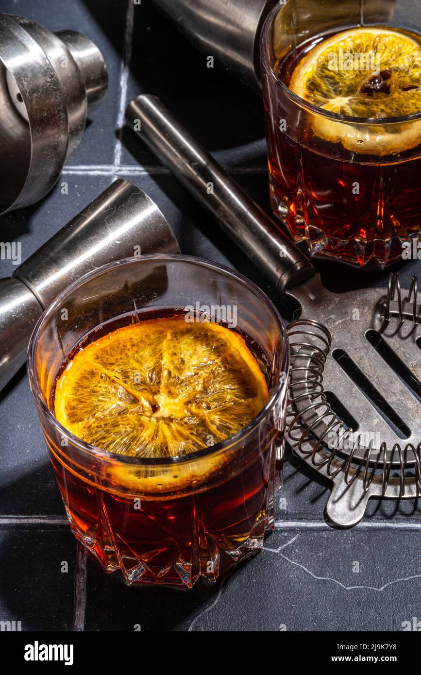 Hard alcohol drink with orange slice garnish. Negroni cocktail with ...