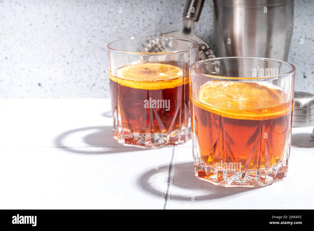 Hard alcohol drink with orange slice garnish. Negroni cocktail with