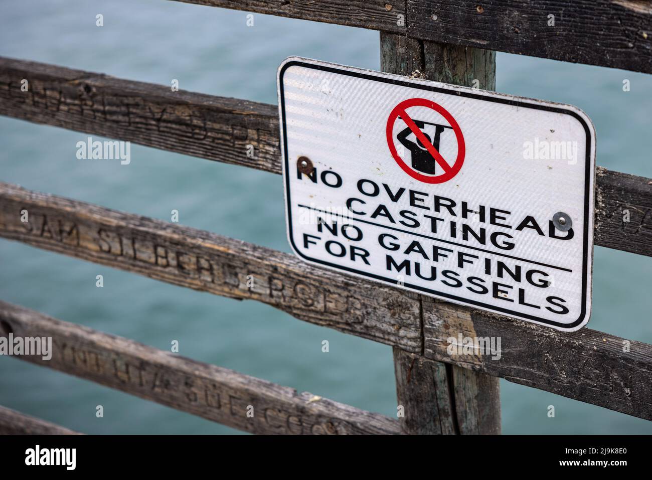 A sign telling fisherman to not overhad cast or gaff for mussels Stock Photo