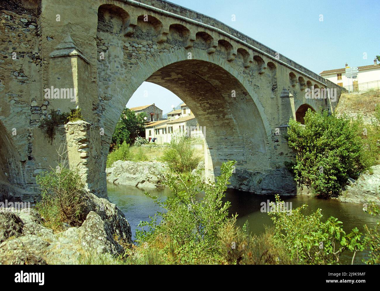 Old Genoese stone bridge, over the dry river bed, Tavignano river, Corsica, France, Mediterranean, Europe Stock Photo
