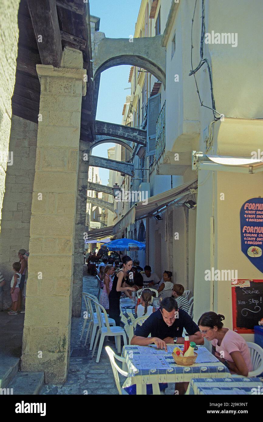 Restaurant in a narrow alley, houses with arches in the historic old town of Bonifacio, Corse-du-Sud, Corsica, France, Mediterranean Sea, Europe Stock Photo