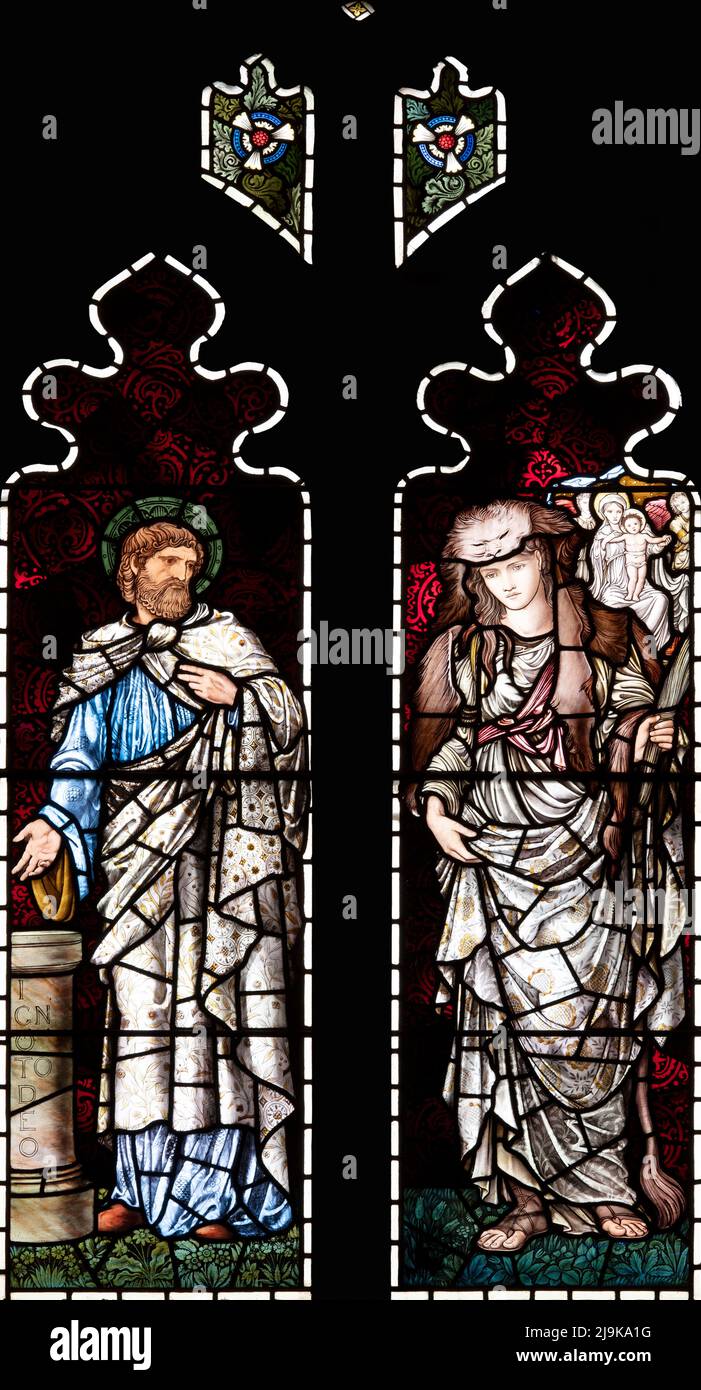 Stained glass by Edward Burne-Jones depicting the Christian message told and foretold by St Paul and Albunea, Irton Church, Cumbria, UK Stock Photo