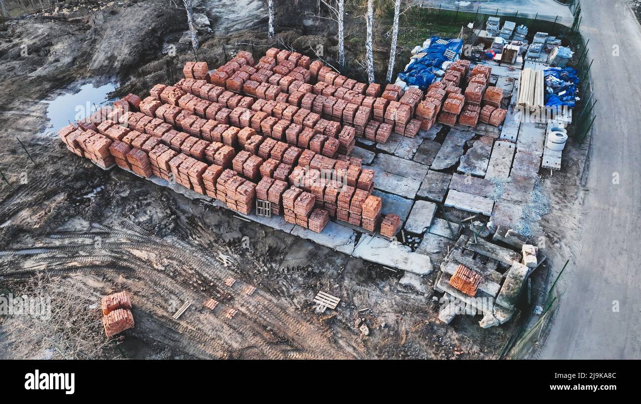 Pallets of bricks for construction. Outdoor storage. Warehousing of large quantities of bricks. Aerial view Stock Photo