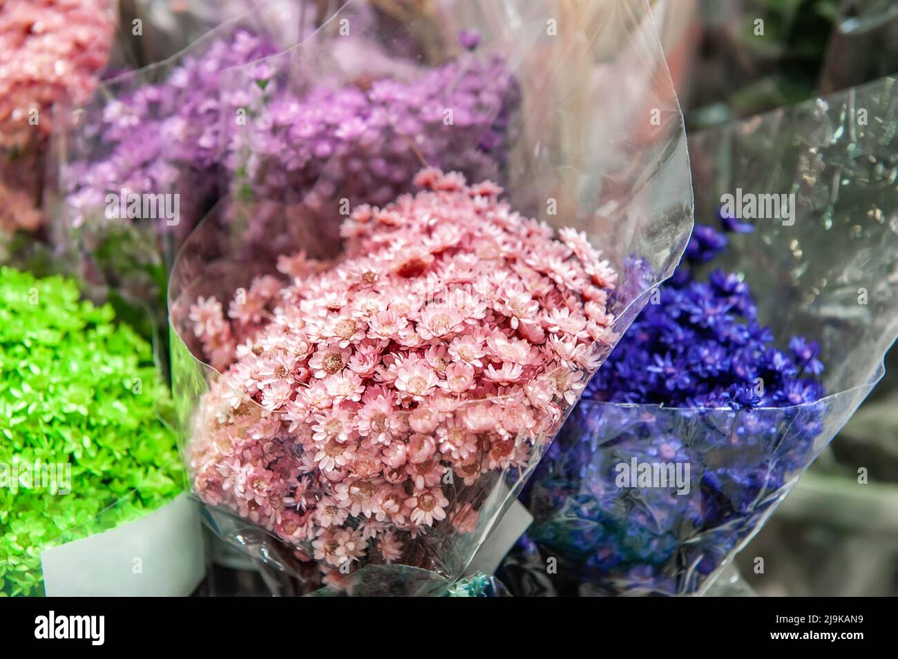 multicolored dried flowers, dry flowers in the workspace of the florist
