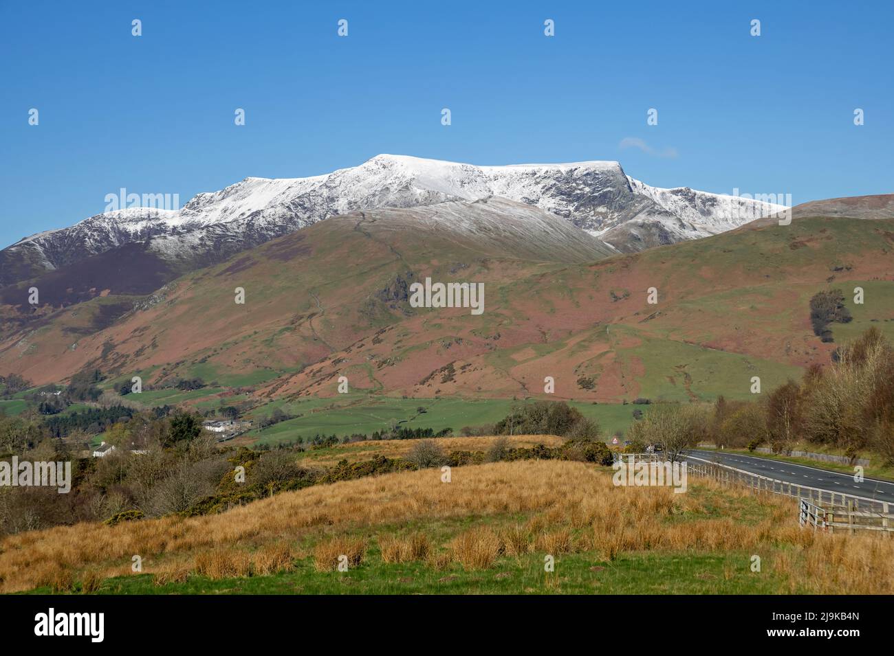 View from the A66 to Keswick towards snow topped Blencathra in spring late winter Lake District National Park Cumbria England UK United Kingdom GB Stock Photo