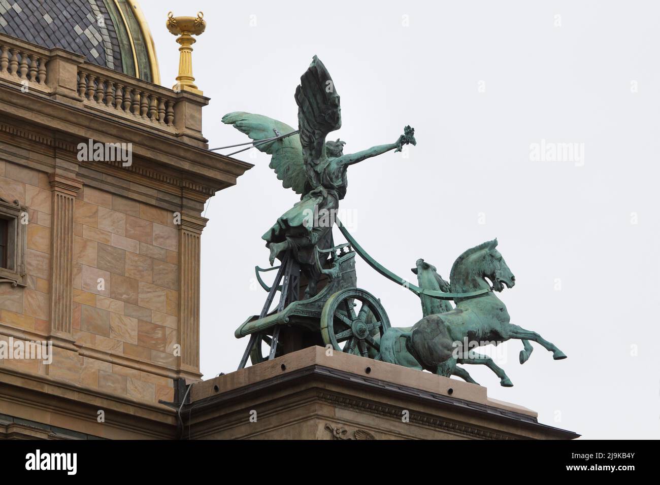 Triga (three-horse chariot) on the roof terrace of the National Theatre (Národní divadlo) in Prague, Czech Republic. The bronze sculptural group designed by Czech sculptor Ladislav Šaloun after a scale model by Czech sculptor Bohuslav Schnirch was completed in 1911. Stock Photo