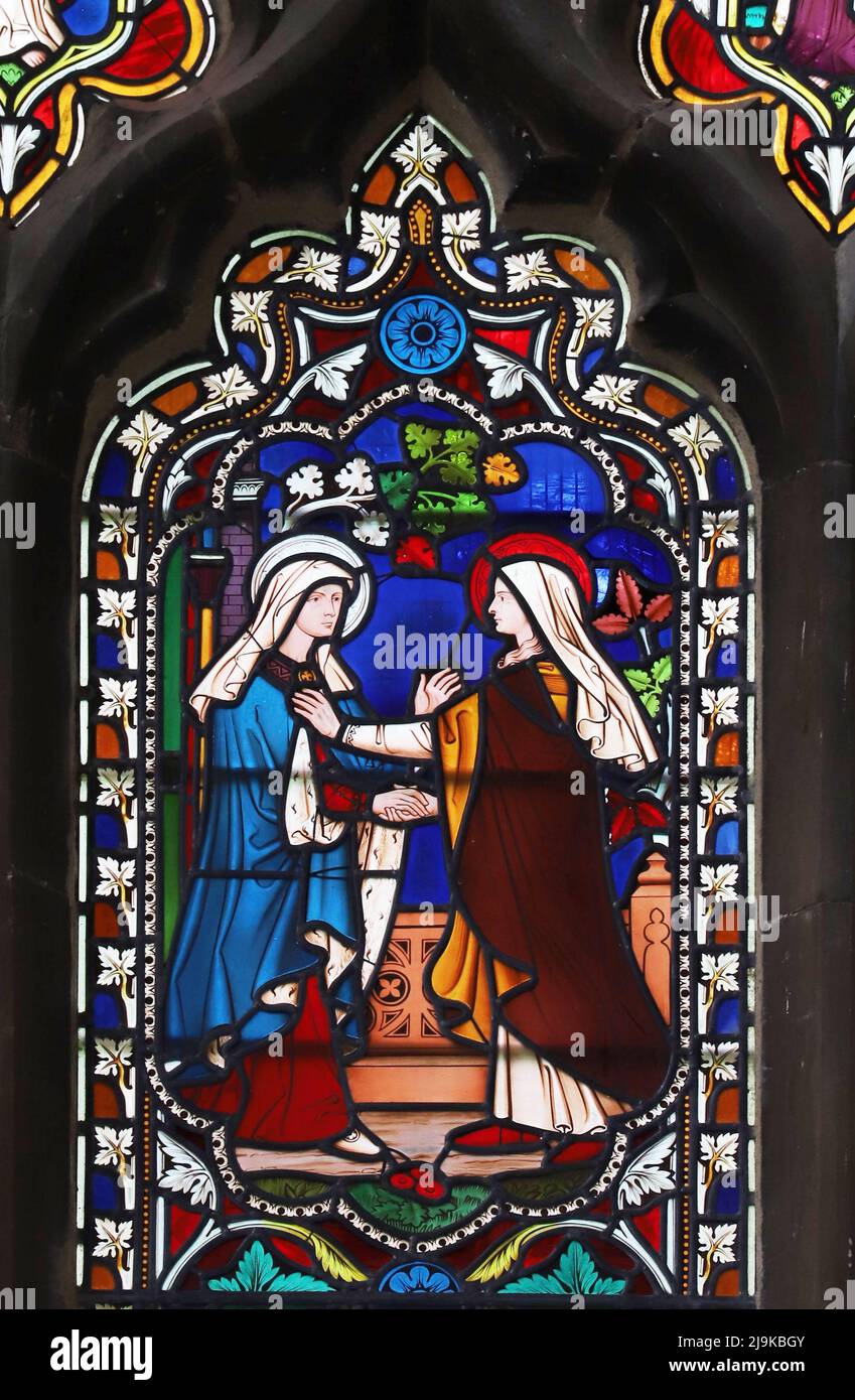 A stained glass window by William Wailes depicting the Visiitation, Saints Peter and Paul Church, King's Sutton, Northamptonshire Stock Photo