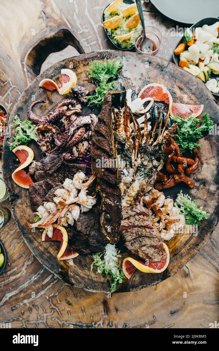 luxury lunch served on a wooden tray with lobster and seafood at a beach club in tulum mexico