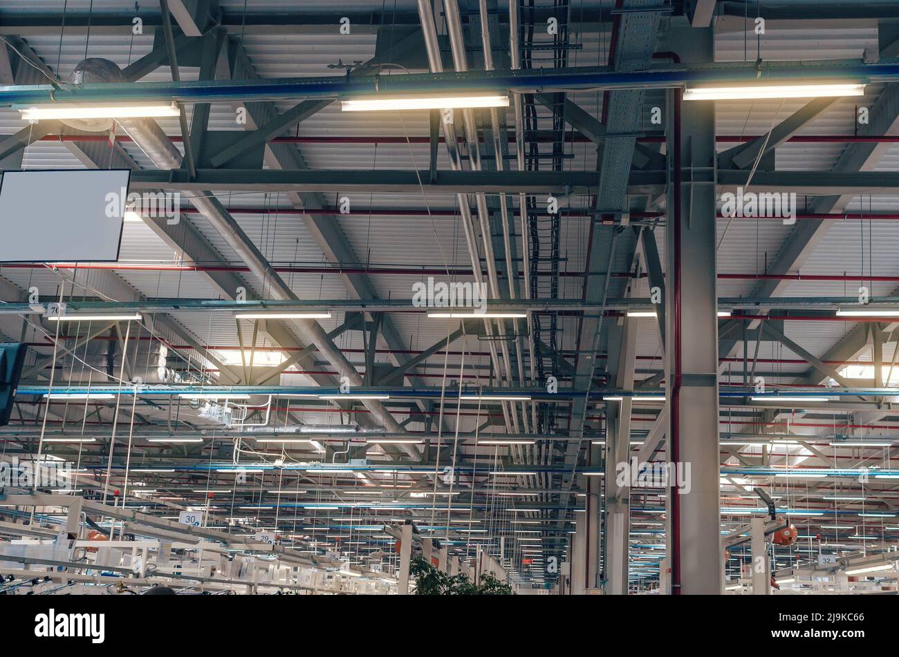 Ceiling of large factory building with artificial lighting. Industrial