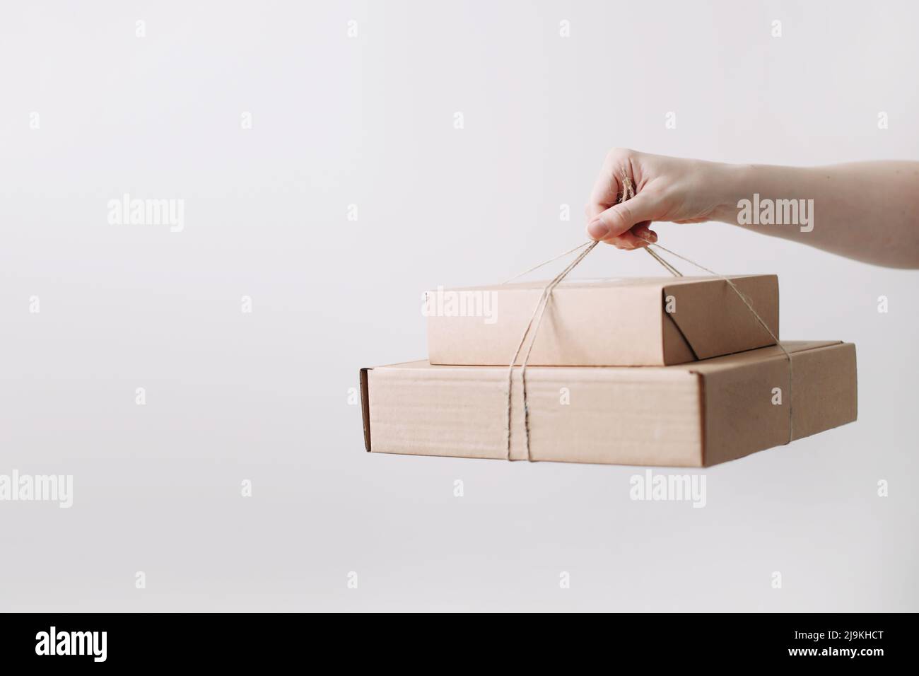 hands holding cardboard boxes. Online shopping and express delivery