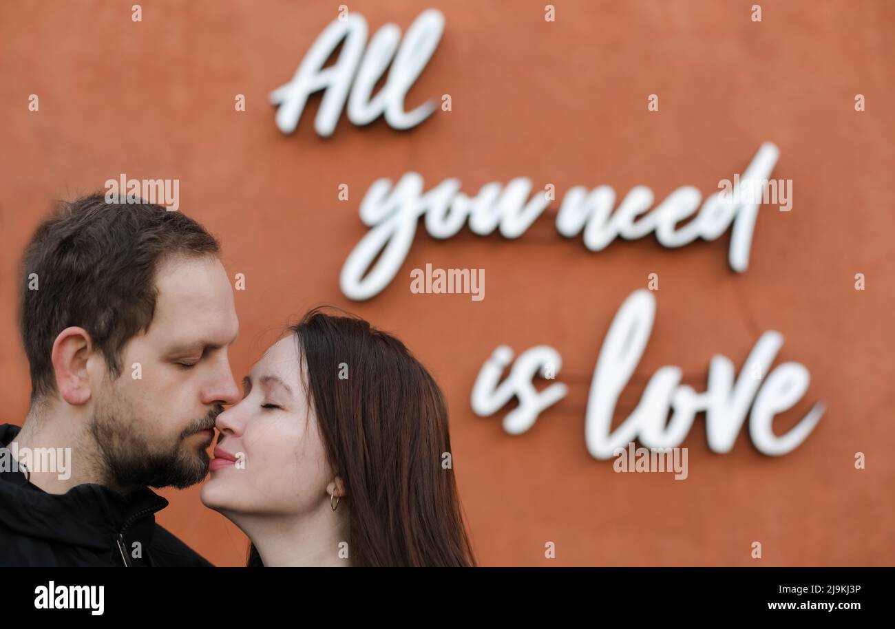 Young happy couple in love. All you need is love message. Stock Photo