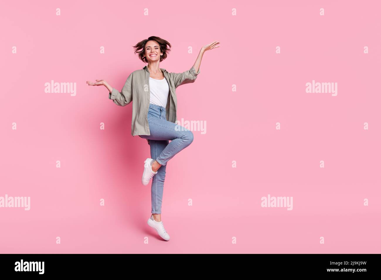 Full length photo of young cheerful lady have fun jump ads advantage ...