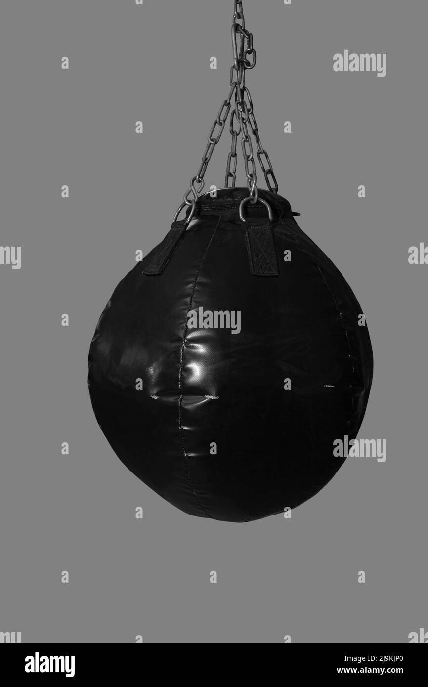 Black speed boxing ball bag hanging on metal chains, cut out Stock Photo