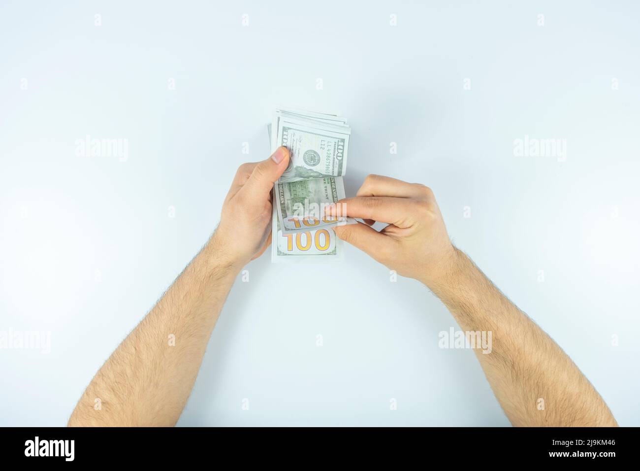 Man counting money with hand, top view, isolated on white background, counting dollar banknotes, wealth concept, make money idea, cash money on hand Stock Photo