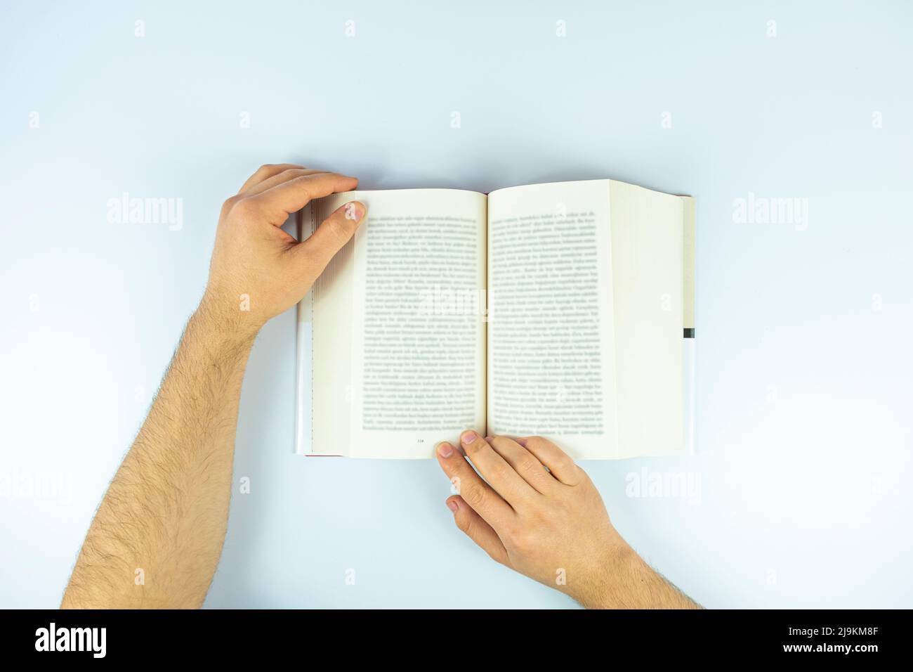 Man hands with open book page isolated on white background, reading book concept, studying and learning idea, top view of book Stock Photo