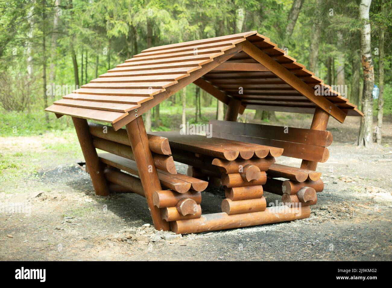 Cabin for relaxation in forest. Place for picnic in nature. Log structure. Place to relax. Stock Photo