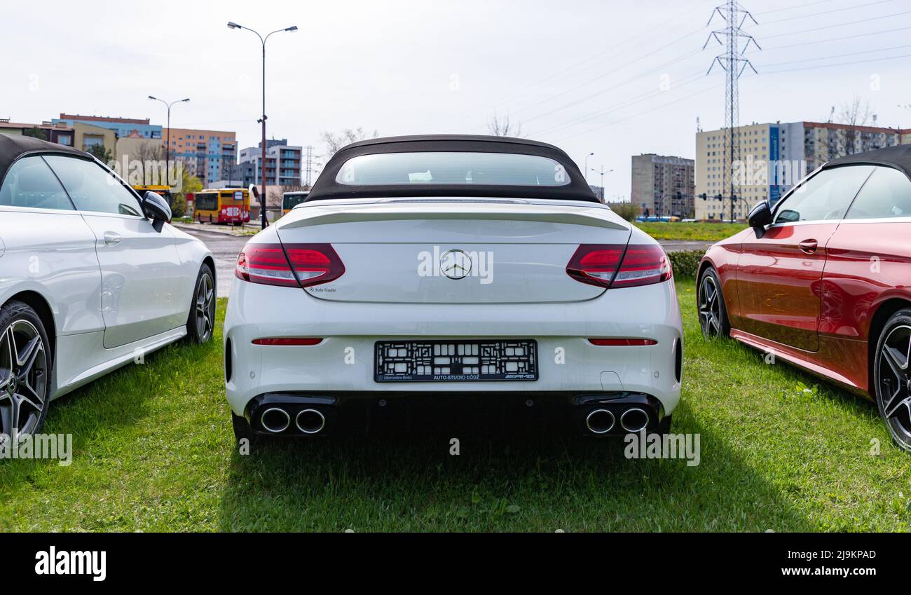 A rear view picture of a white Mercedes Benz Class C Cabrio at a car dealership. Stock Photo