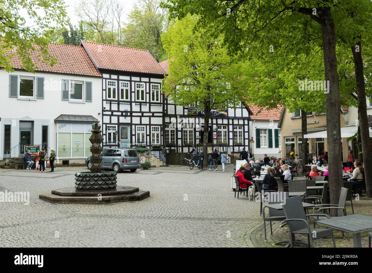 people enjoy the good weather with a drink on the terrace in the centre of tecklenburg Stock Photo