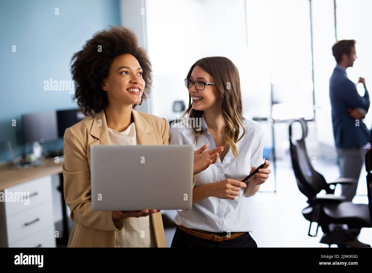 Happy multiethnic business women working together online on a laptop in ...