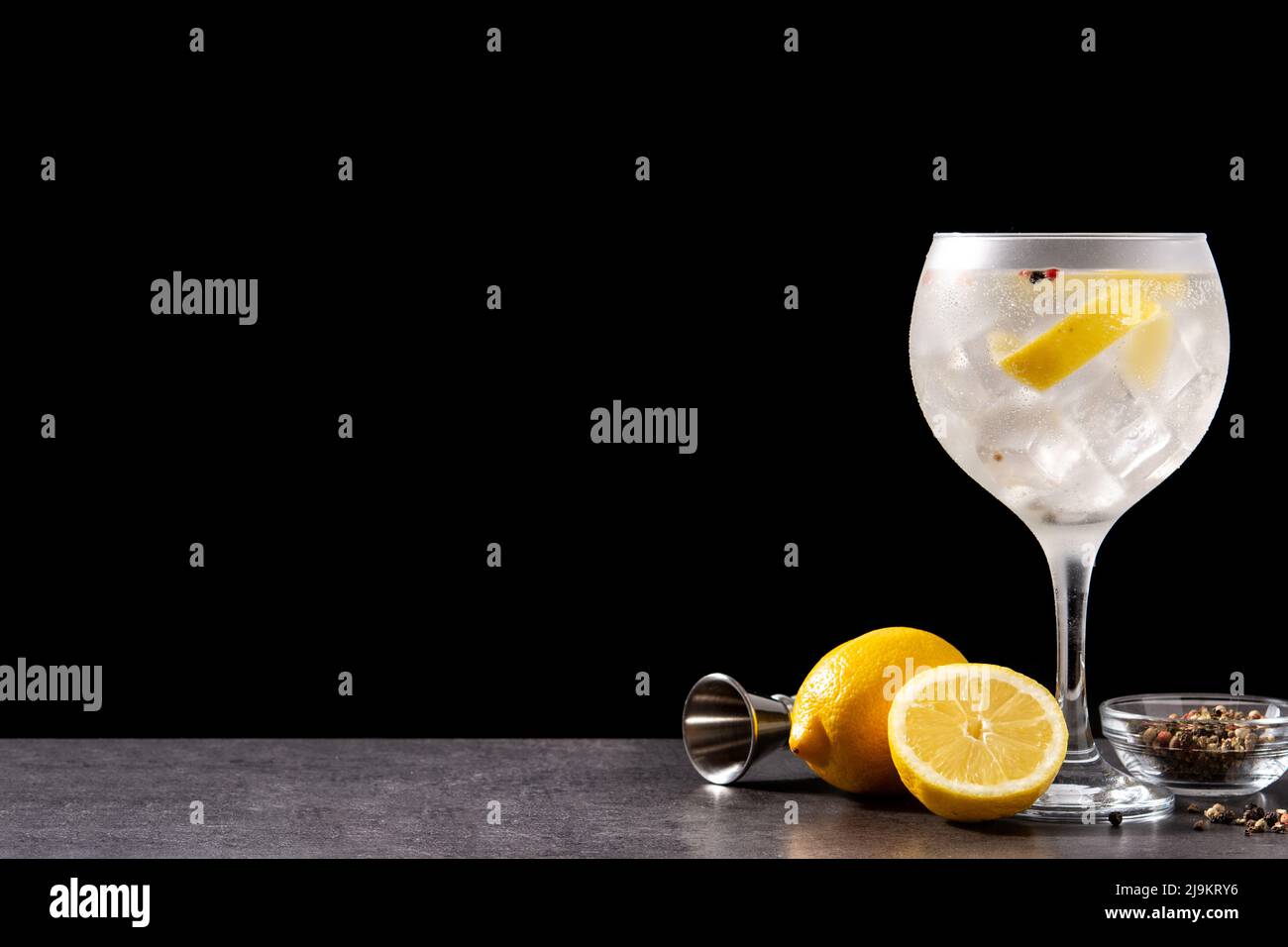Gin tonic cocktail drink into a glass on black background Stock Photo