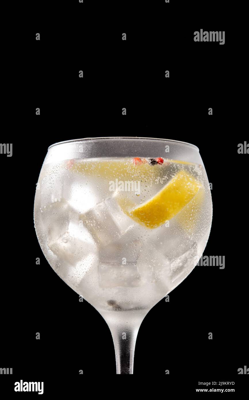Gin tonic cocktail drink into a glass on black background Stock Photo