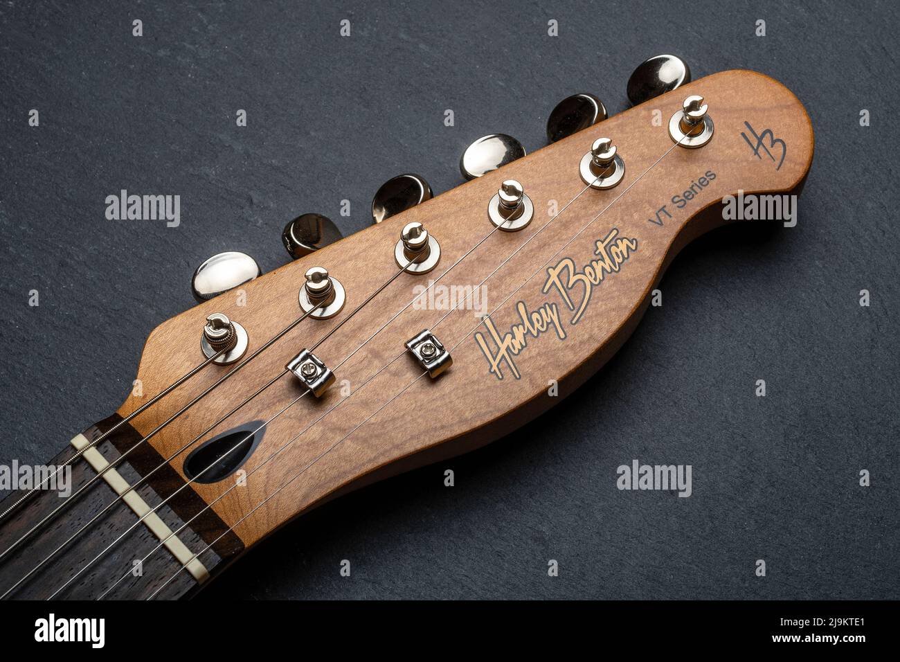 Carrara, Italy - May 24, 2022 - Headstock of a Harley Benton guitar with vintage tuners Stock Photo