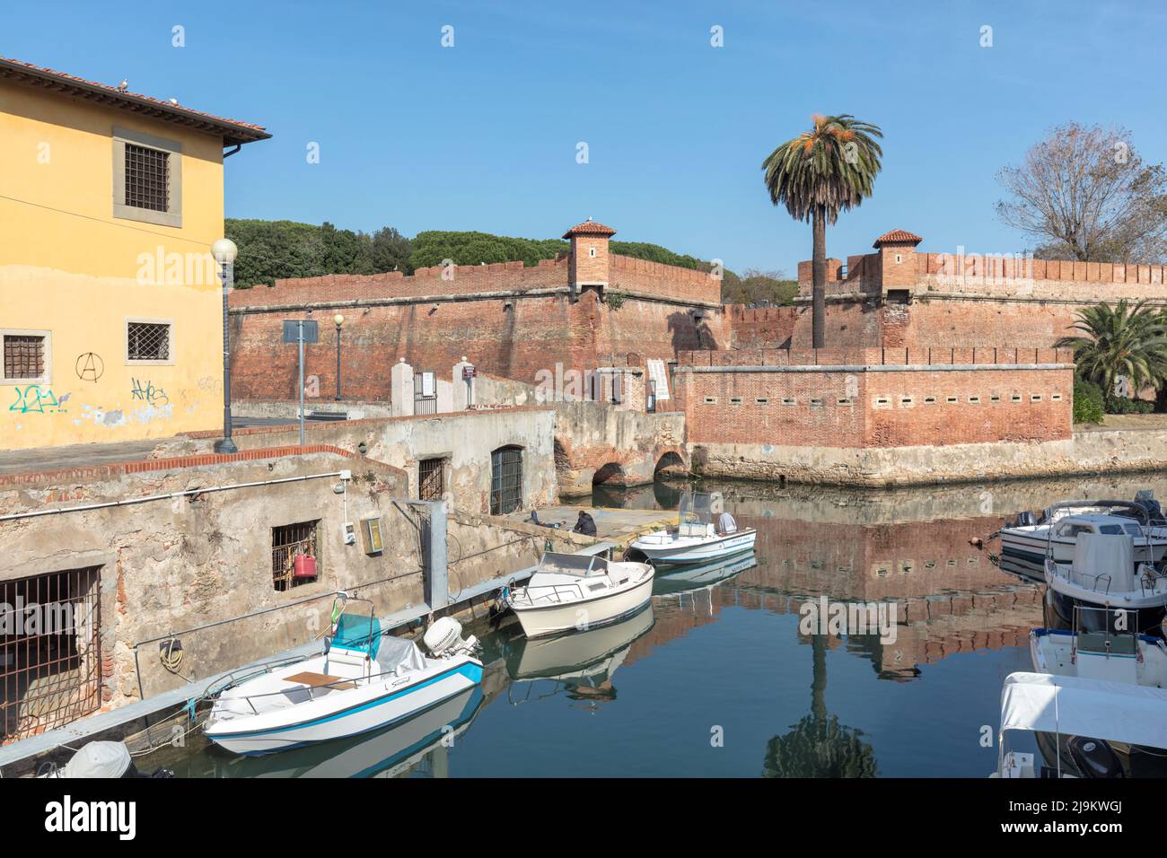 Fortezza Nuova, fortress completed in 1604, in Scali della Fortezza Nuova, surrounded by boats in historic canal, Livorno, Tuscany, Italy Stock Photo