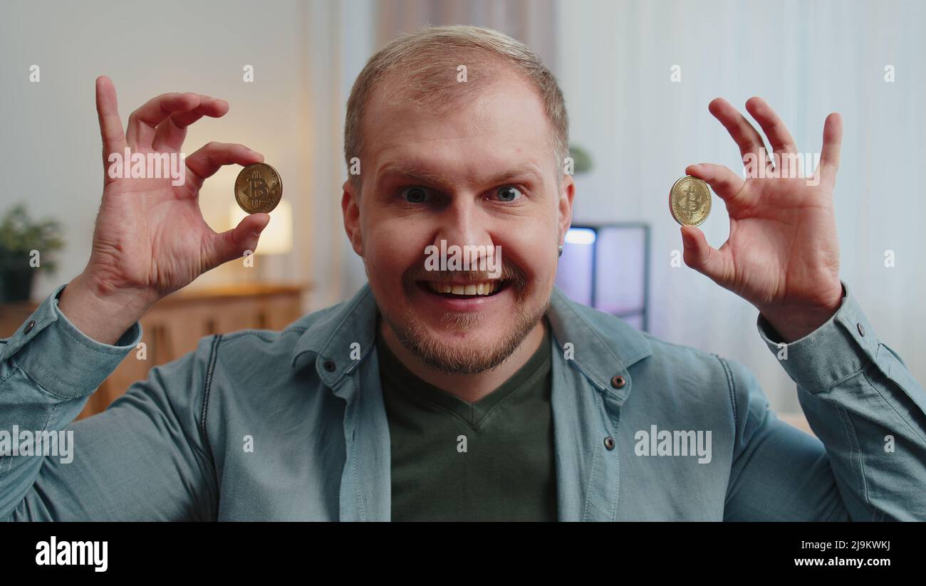 Guy stock trader earning bitcoins after online monitoring trading  operations mining hold BTC coins Stock Photo - Alamy