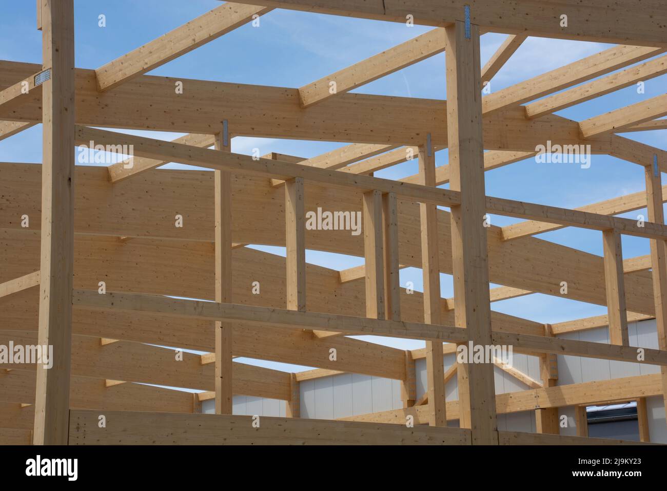 large wooden beams of a roof and side construction connected with large steel screws Stock Photo