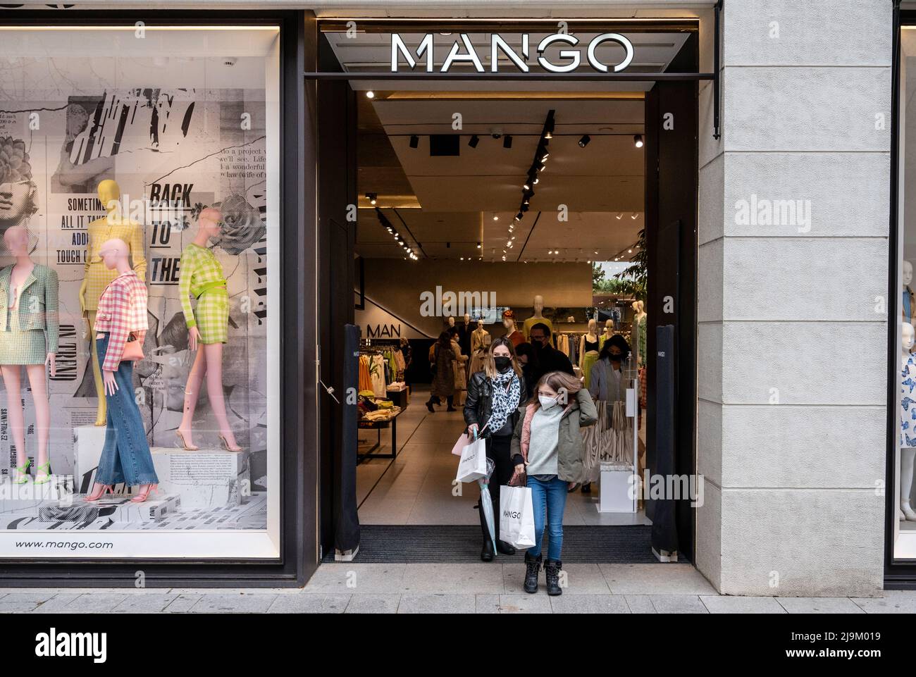 Shoppers leave the Spanish multinational clothing brand Mango store in ...