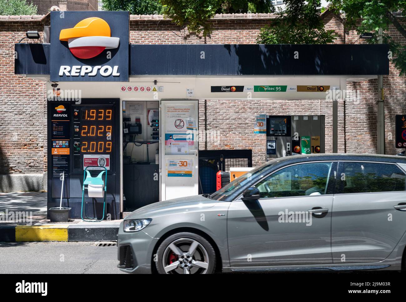A vehicle drives past a small gas station from the Spanish fossil fuel