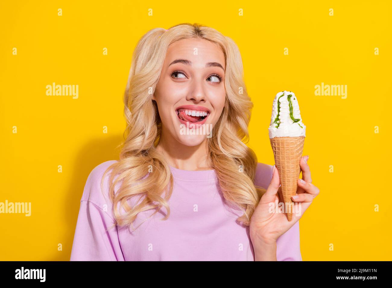 Photo of funny positive lady hold ice cream tongue lick teeth look ...