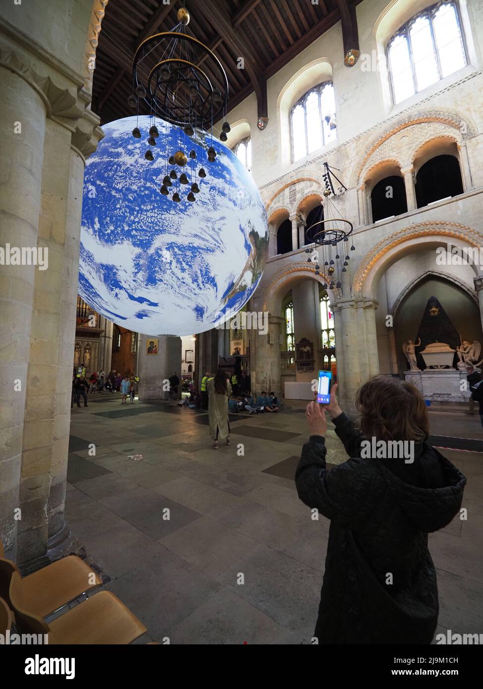 Rochester, Kent, UK. 24th May, 2022. Luke Jerram's 'Gaia' artwork -  a detailed replica of planet Earth - has been installed inside Rochester Cathedral in Kent. It opened to the public today and is on display until June 12. Credit: James Bell/Alamy Live News Stock Photo