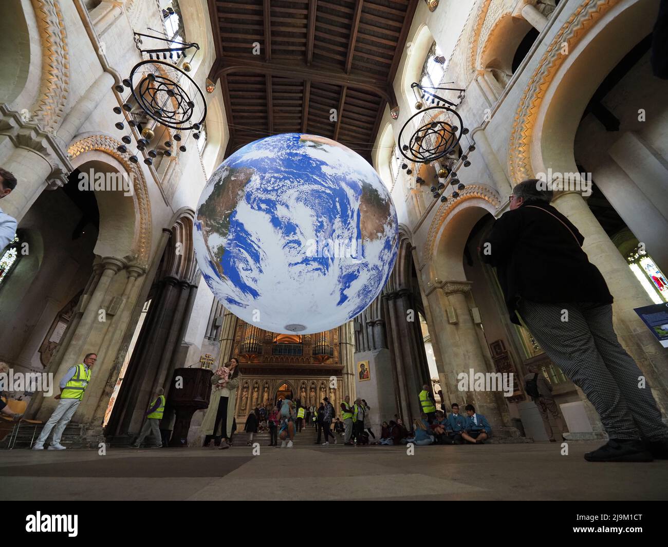 Rochester, Kent, UK. 24th May, 2022. Luke Jerram's 'Gaia' artwork -  a detailed replica of planet Earth - has been installed inside Rochester Cathedral in Kent. It opened to the public today and is on display until June 12. Credit: James Bell/Alamy Live News Stock Photo