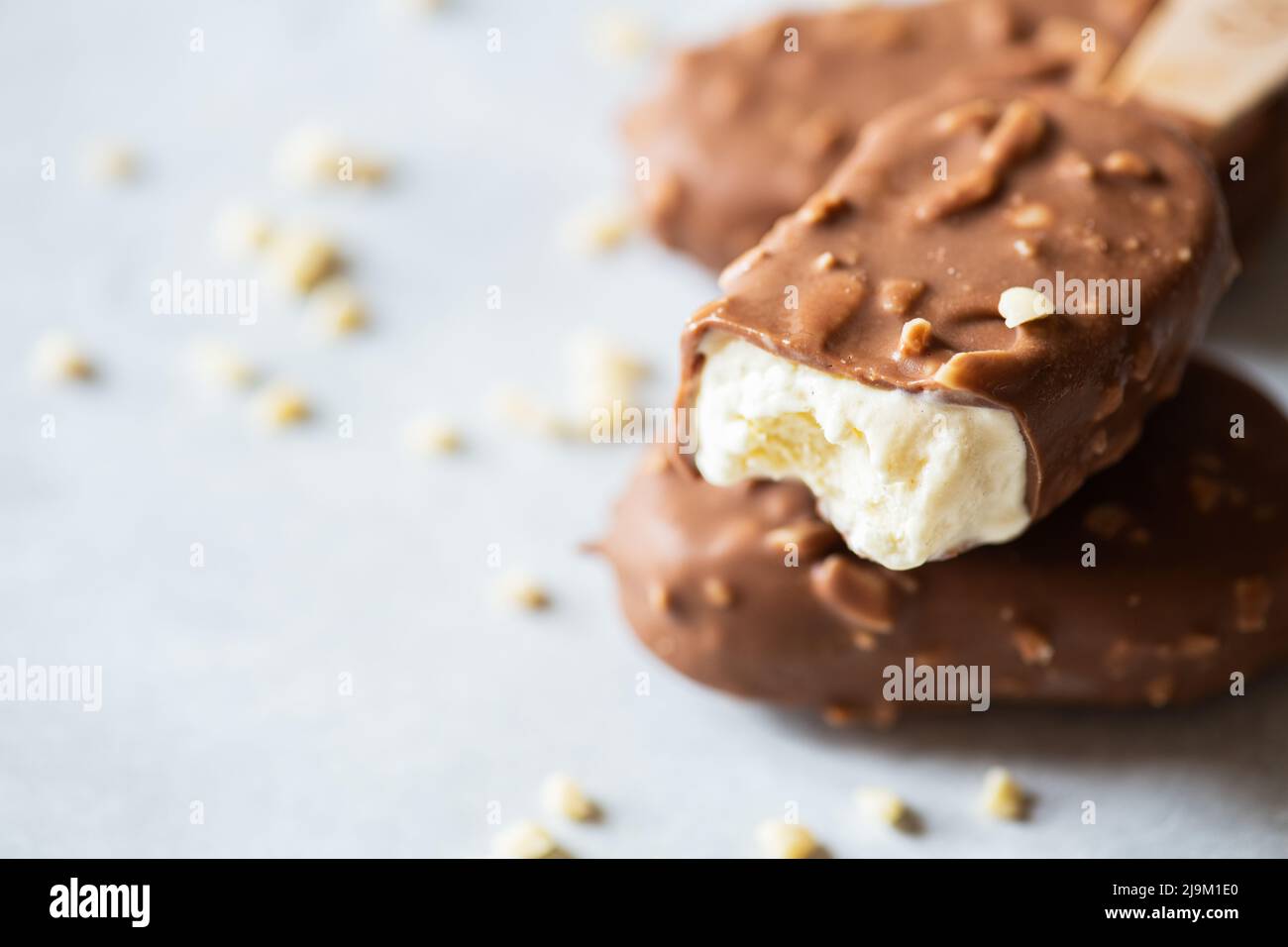 Bited Bited almond vanilla ice-cream with chocolate glaze Stock Photo - Alamy