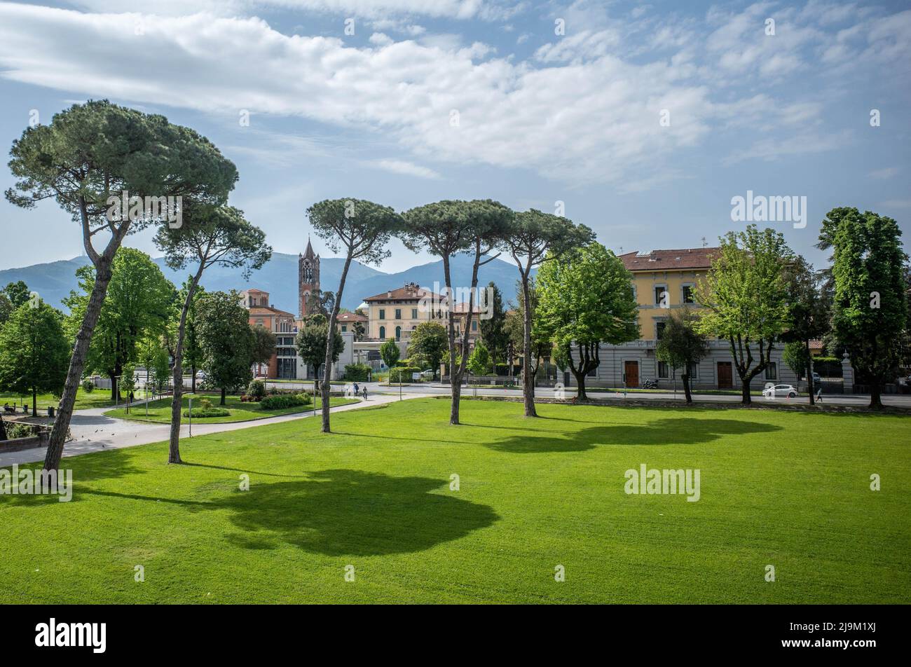 Luuca, Tuscany, Italy, 08 May 2022 - Park land outside Medieval city walls of Lucca, with grass tall trees and blue sky. Stock Photo
