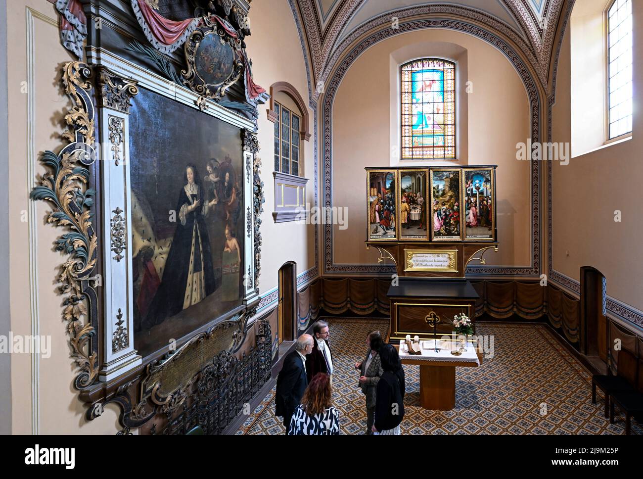 24 May 2022, Saxony-Anhalt, Köthen: Next to the epitaph (l) with the founder's picture of Princess Gisela Agnes by the Prussian court painter Antoine Pesne stands the late Gothic high altar in the Protestant church of St. Agnus in Köthen. The art-historically valuable altar with neo-Gothic elements was lavishly restored and is now back in its original place in the renovated church. The work originates from a Central German workshop and dates back to around 1510. Presumably the altar originally stood in the Merseburg Cathedral and then came to Köthen. Depicted is the adoration of the Eucharist Stock Photo