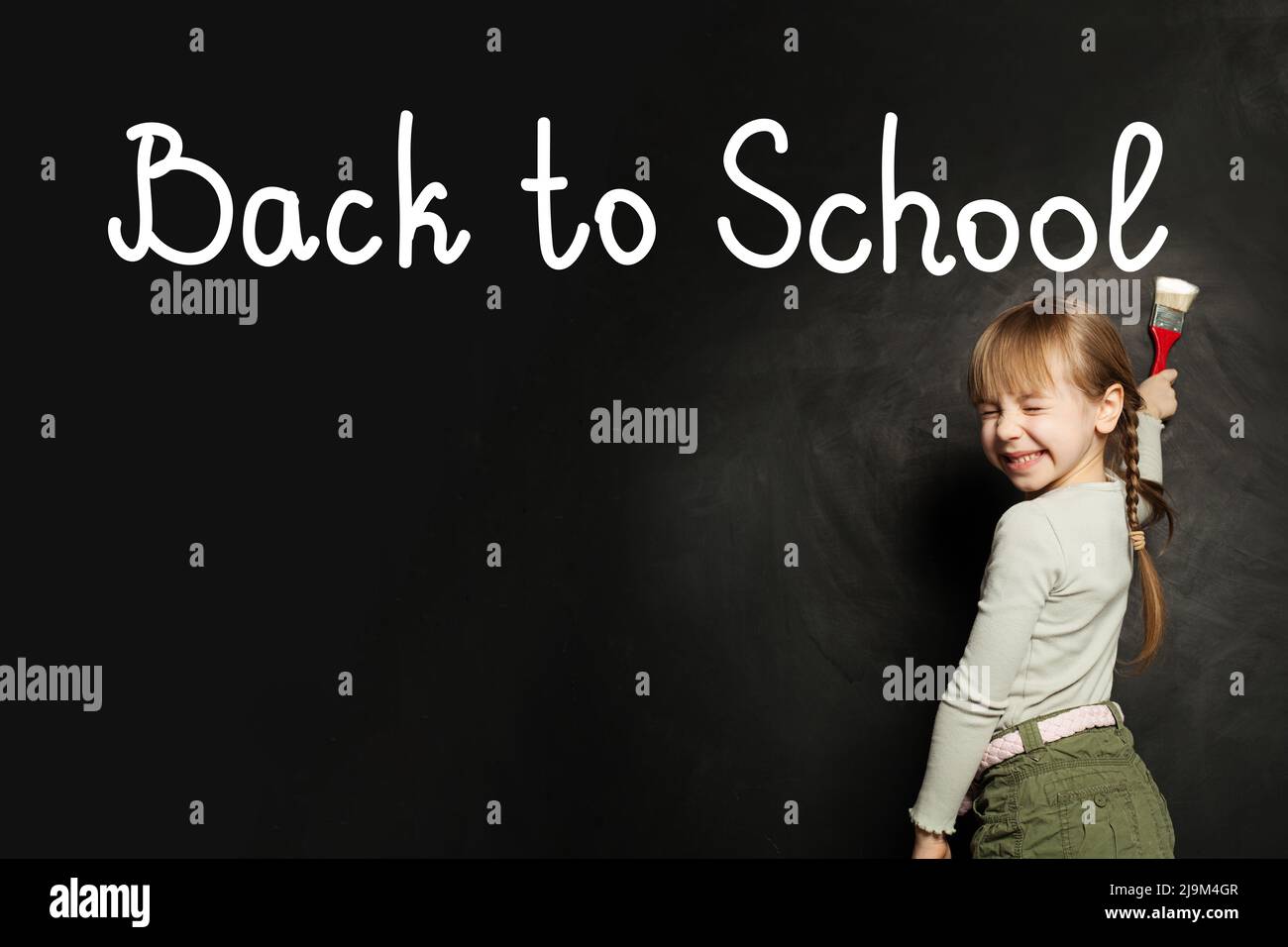 Happy adorable cute laughing child girl writing Back to school on ...