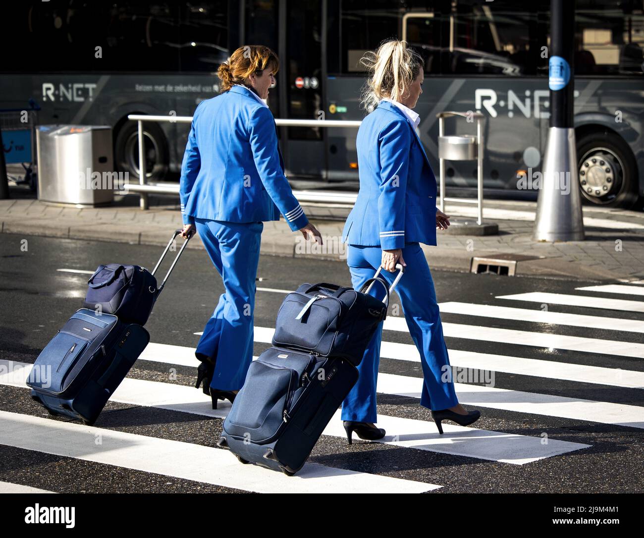 SCHIPHOL, Amsterdam, 2022-05-24 09:17:40 SCHIPHOL - KLM flight attendants walk across Schiphol Airport. Aviation group Air France-KLM wants to raise almost 2.3 billion euros with the issue of shares to pay back the state aid received during the corona crisis more quickly and to strengthen its balance sheet. ANP RAMON VAN FLYMEN netherlands out - belgium out Stock Photo